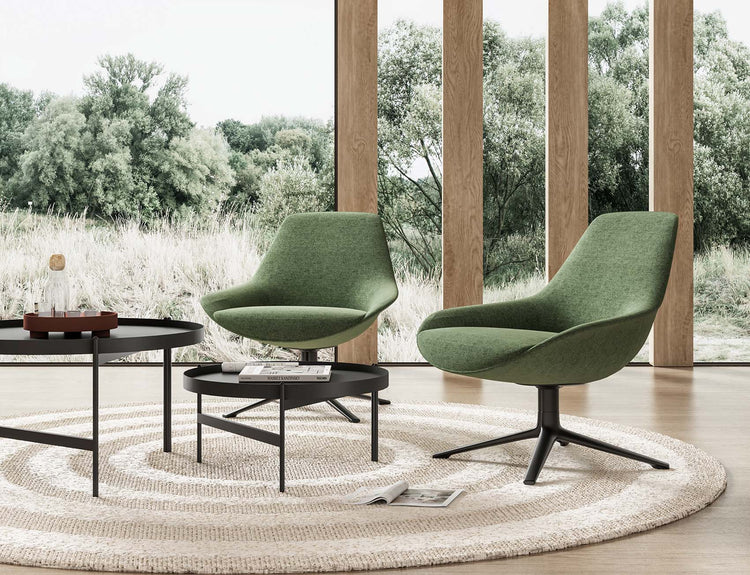 Green lounge chairs with black side tables in a furnished lounge