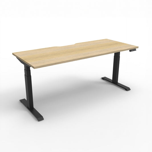 Boost+ electric single desk, Natural Oak / Black Satin, without screen or cable tray. Representative image; proportions vary by size.
